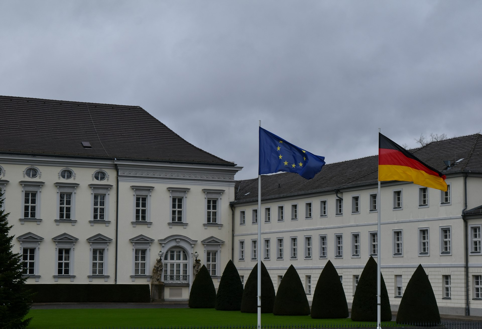 A large white building with a flag on top of it